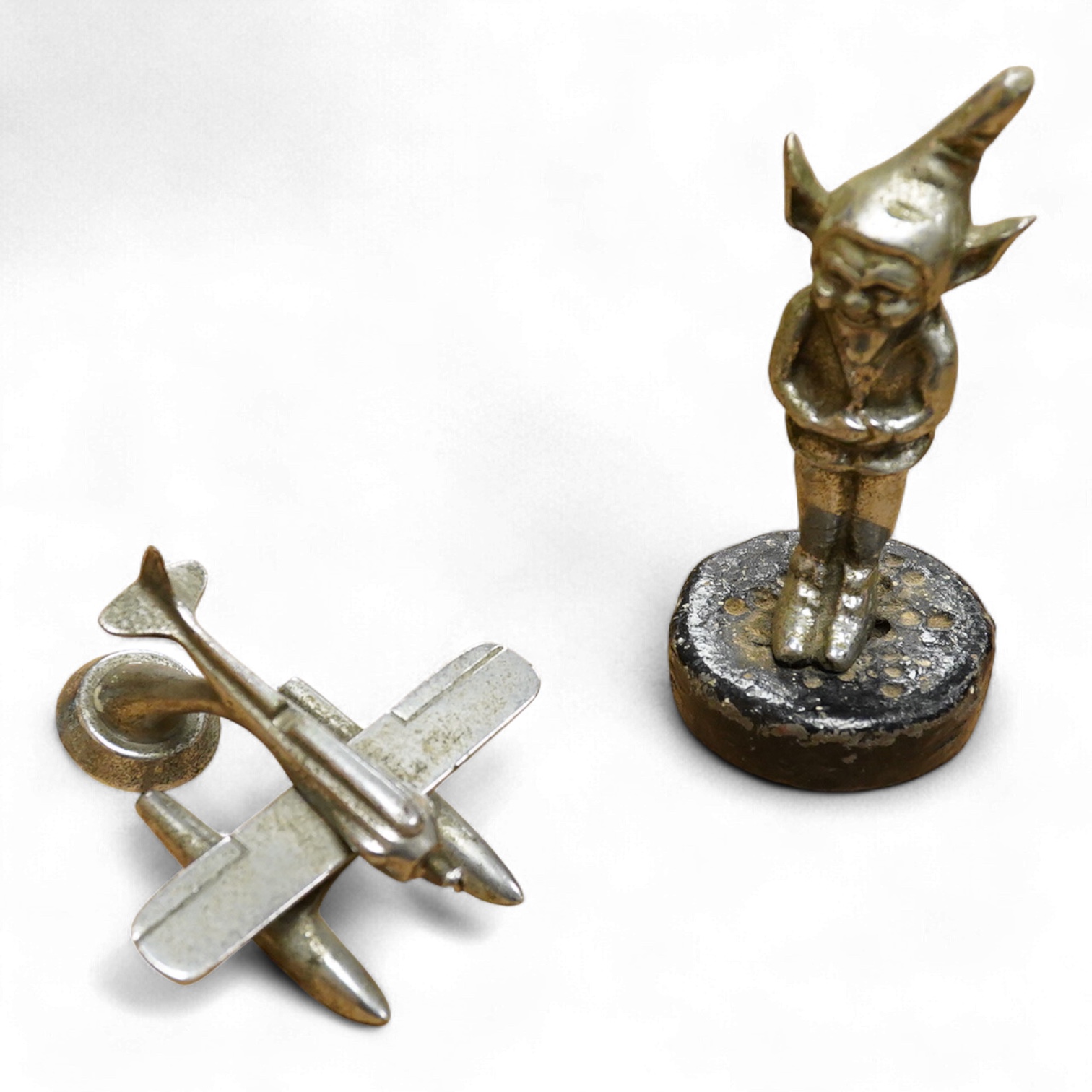 A chrome seaplane car mascot (lacking propellor) and a chrome imp car mascot- 14cm high